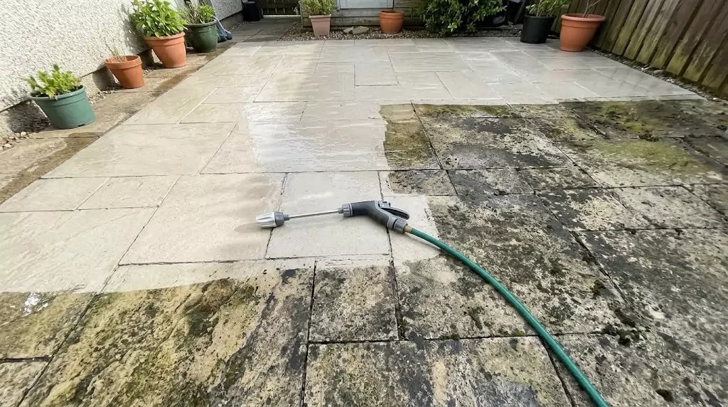 Jetterix test on a 350-sq-ft stone patio — clear line between cleaned and uncleaned section